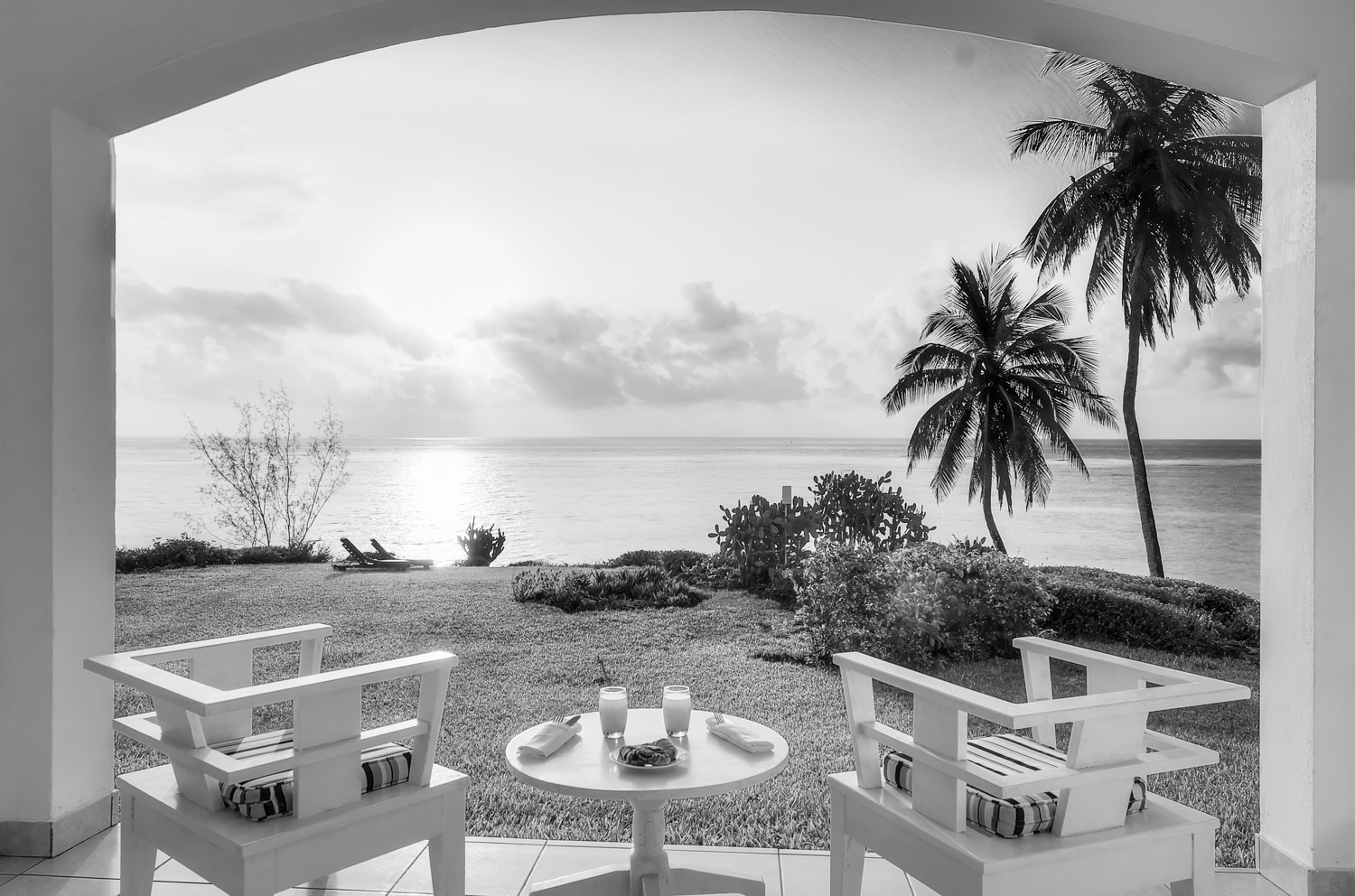 An arched view onto the ocean at sunrise.